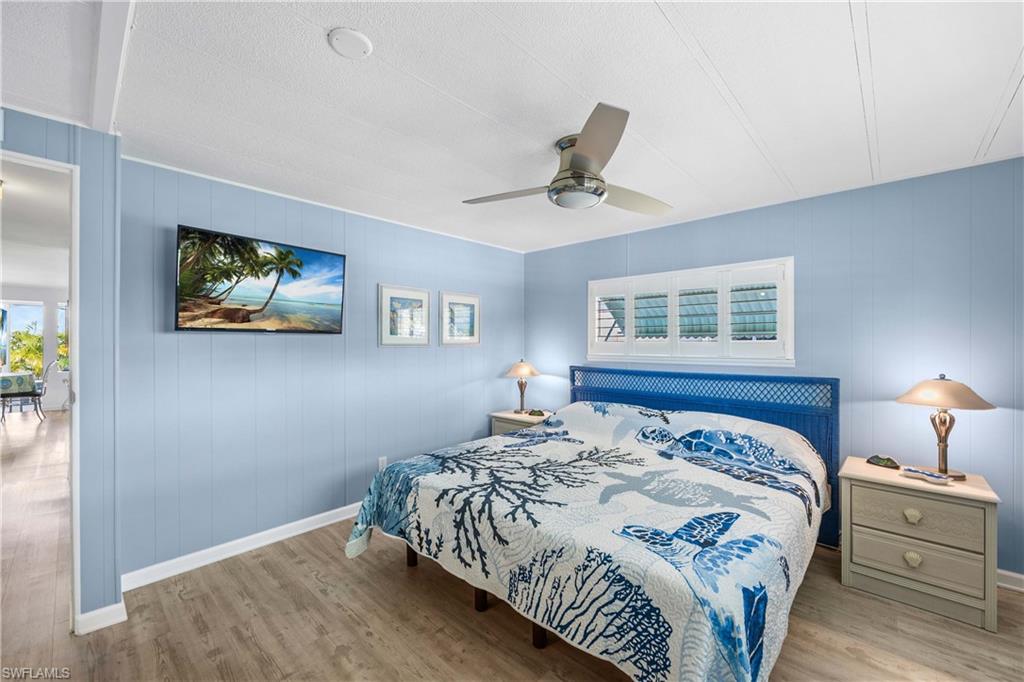 216 Rookery Road Naples, FL 34114 - Photo 17 of 44 a bedroom with a large bed and a window