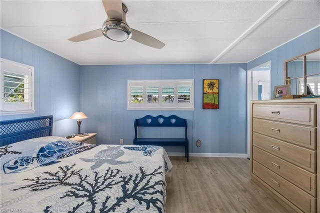 a bedroom with a bed and a lamp on dresser