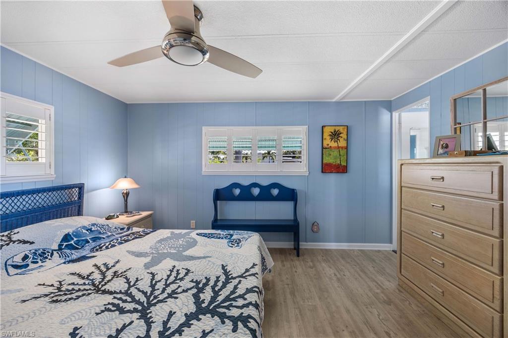 216 Rookery Road Naples, FL 34114 - Photo 18 of 44 a bedroom with a bed and a lamp on dresser