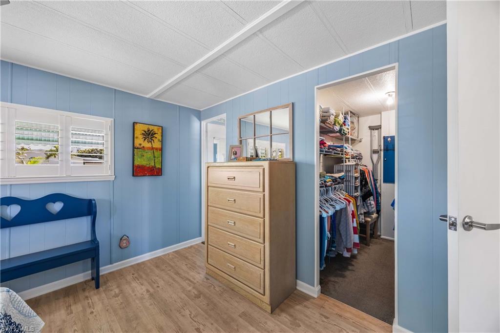 216 Rookery Road Naples, FL 34114 - Photo 19 of 44 a view of walk in closet with clothes and shoes