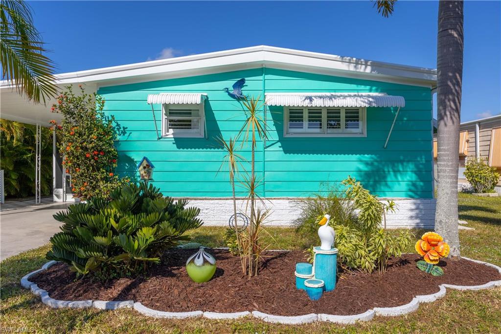 216 Rookery Road Naples, FL 34114 - Photo 2 of 44 a front view of a house with a chairs and table