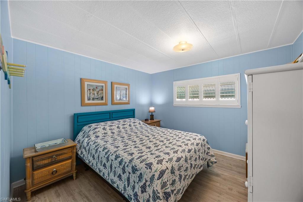 216 Rookery Road Naples, FL 34114 - Photo 21 of 44 a bedroom with a bed and a night stand