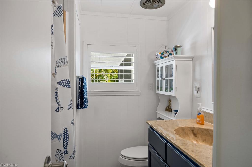 216 Rookery Road Naples, FL 34114 - Photo 22 of 44 a bathroom with a granite countertop sink toilet and mirror