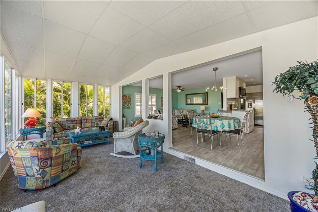 216 Rookery Road Naples, FL 34114 - Photo 25 of 44 a living room with furniture and a large window