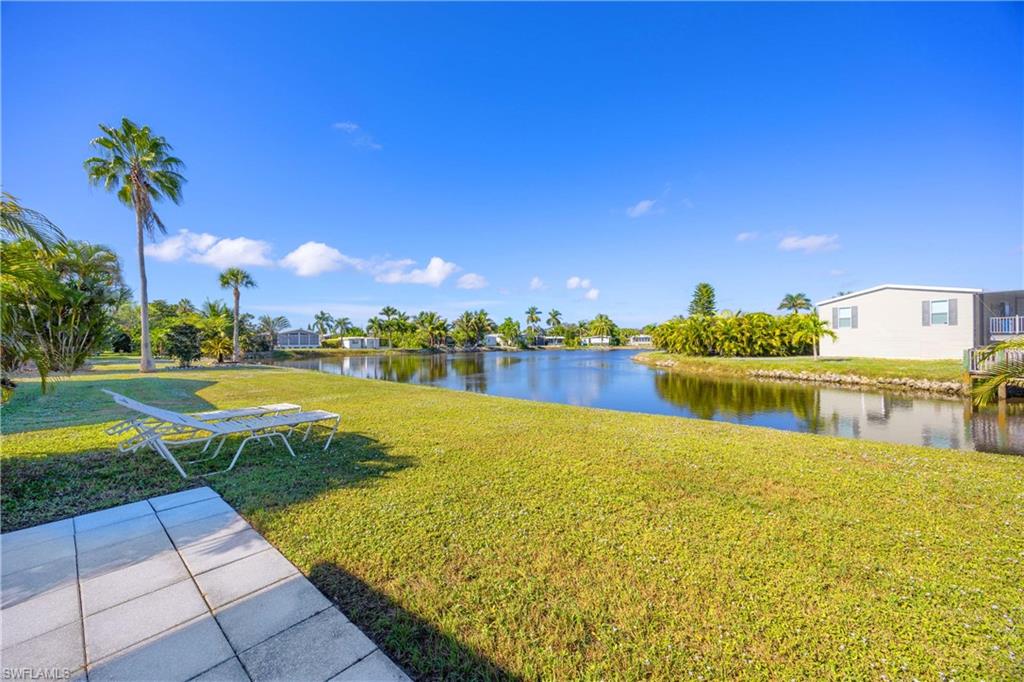 216 Rookery Road Naples, FL 34114 - Photo 29 of 44 a view of a lake with a house in the background