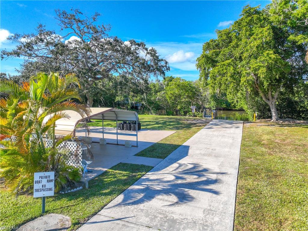 216 Rookery Road Naples, FL 34114 - Photo 34 of 44 a view of swimming pool with a garden