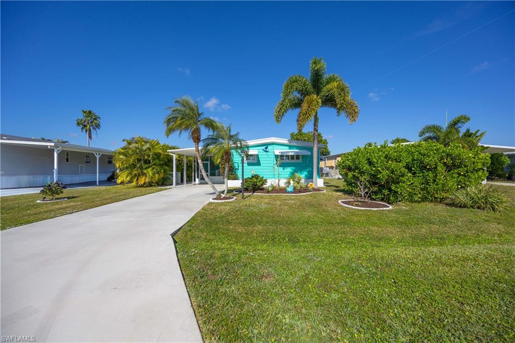 216 Rookery Road Naples, FL 34114 - Photo 39 of 44 a front view of a house with garden