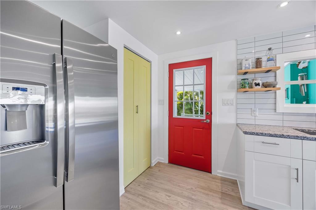 216 Rookery Road Naples, FL 34114 - Photo 5 of 44 a kitchen with stainless steel appliances granite countertop a refrigerator and a sink