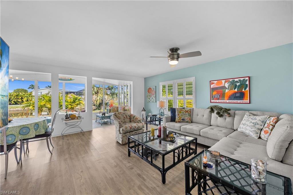216 Rookery Road Naples, FL 34114 - Photo 6 of 44 a living room with furniture and a wooden floor
