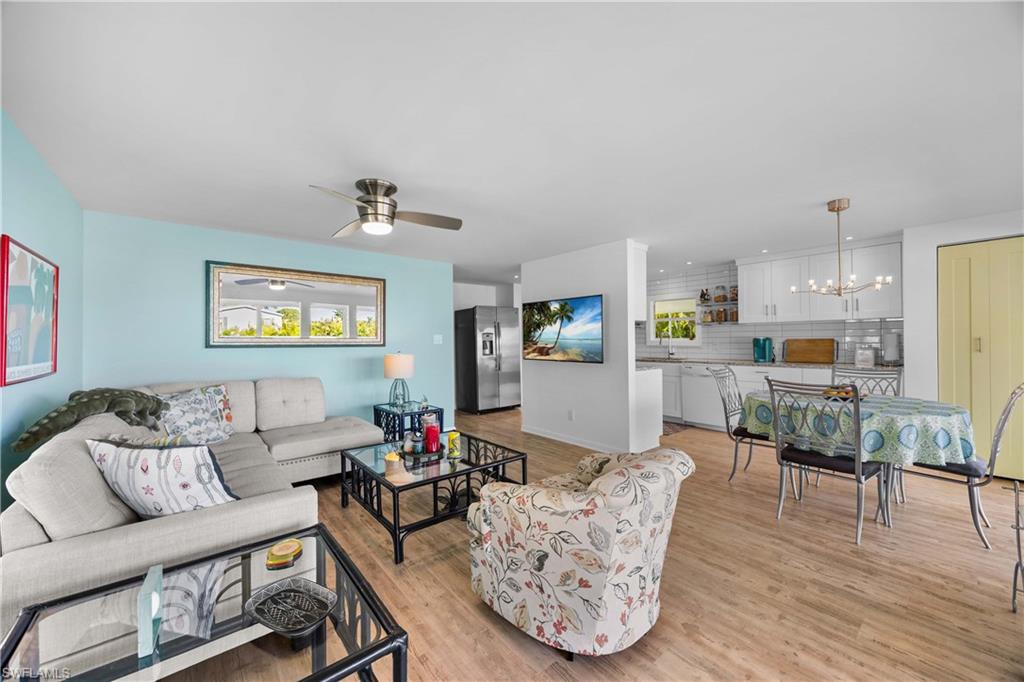 216 Rookery Road Naples, FL 34114 - Photo 8 of 44 a living room with furniture and wooden floor