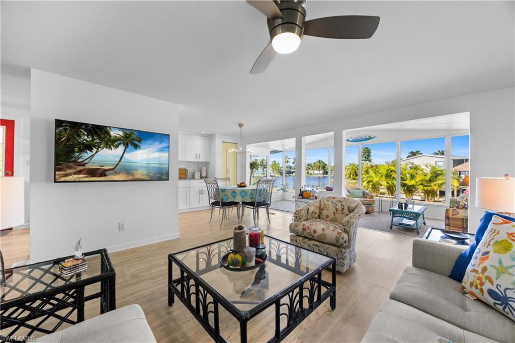 216 Rookery Road Naples, FL 34114 - Photo 9 of 44 a living room with furniture and a large window
