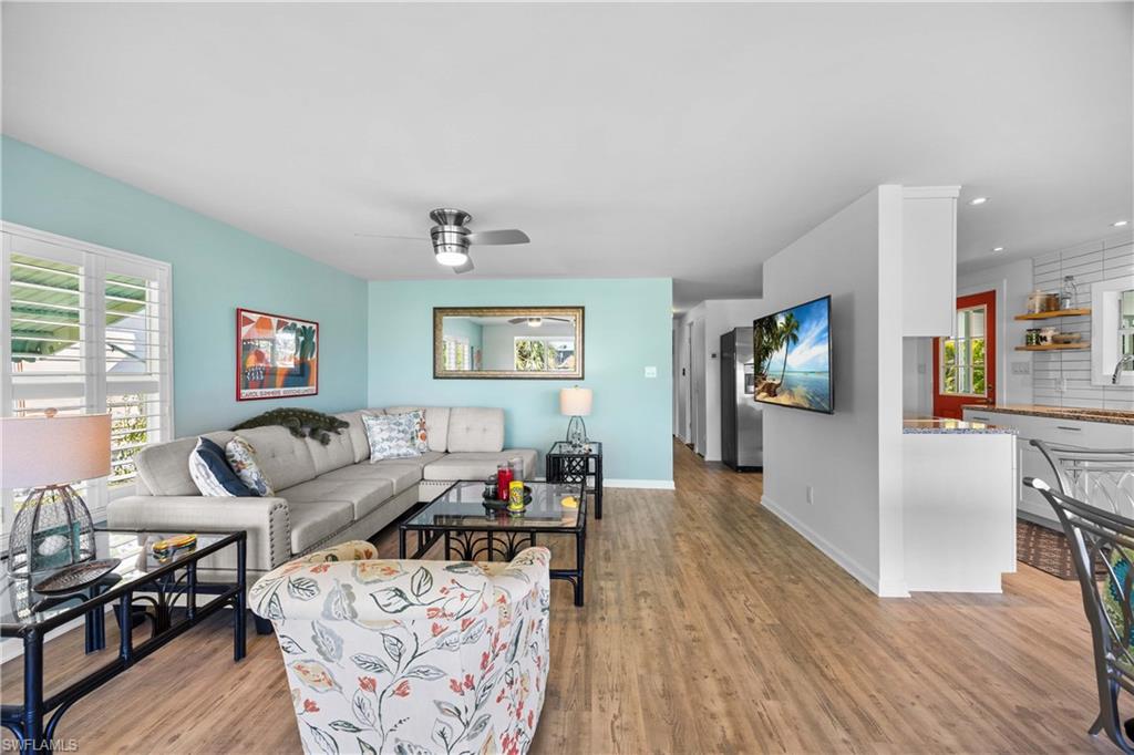 216 Rookery Road Naples, FL 34114 - Photo 10 of 44 a living room with furniture and a wooden floor