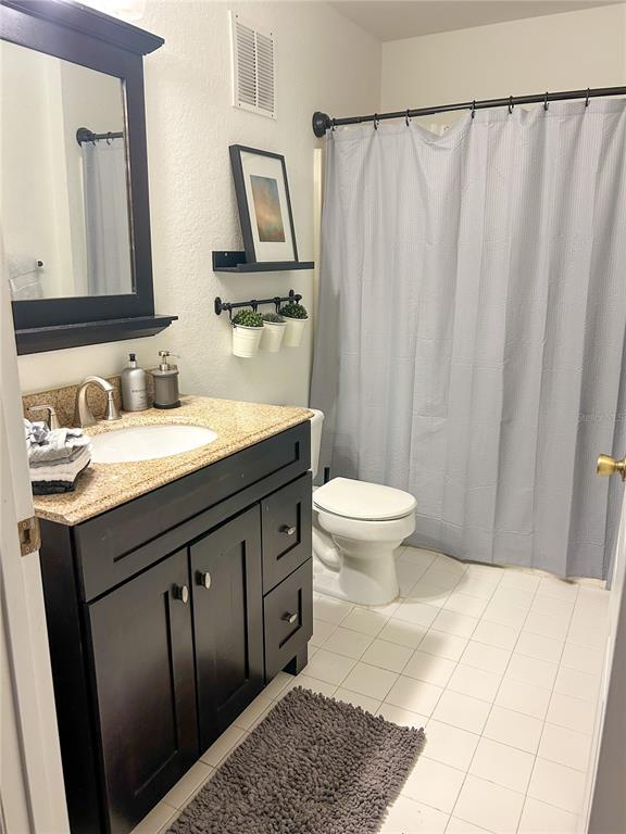 5447 Vineland Road, Unit 1209 Orlando, FL 32811 - Photo 11 of 27 a bathroom with a sink and a mirror