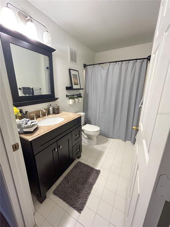 5447 Vineland Road, Unit 1209 Orlando, FL 32811 - Photo 12 of 27 a bathroom with a sink vanity and a mirror