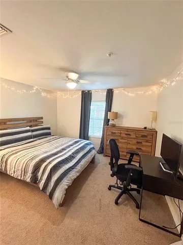 a bedroom with a bed and a desk