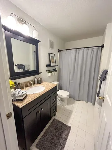 a bathroom with a double vanity sink and mirror
