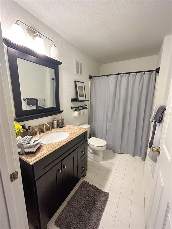5447 Vineland Road, Unit 1209 Orlando, FL 32811 - Photo 16 of 27 a bathroom with a double vanity sink and mirror