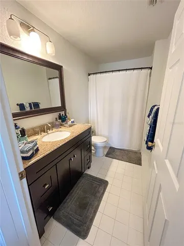 a bathroom with a sink a mirror and a toilet
