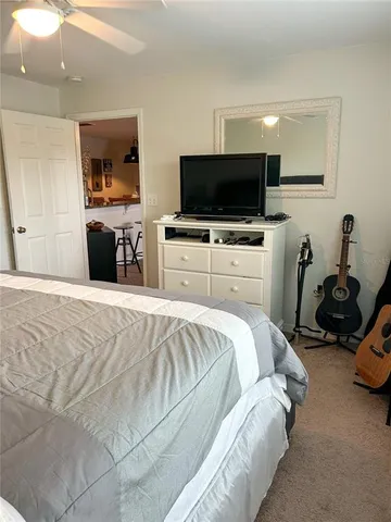 a bedroom with a bed and a television