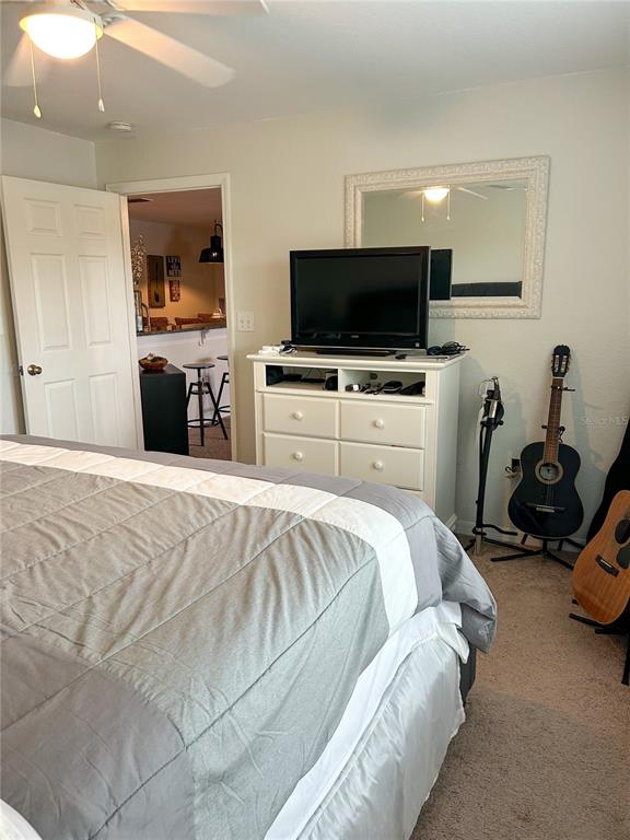 5447 Vineland Road, Unit 1209 Orlando, FL 32811 - Photo 23 of 27 a bedroom with a bed and a television