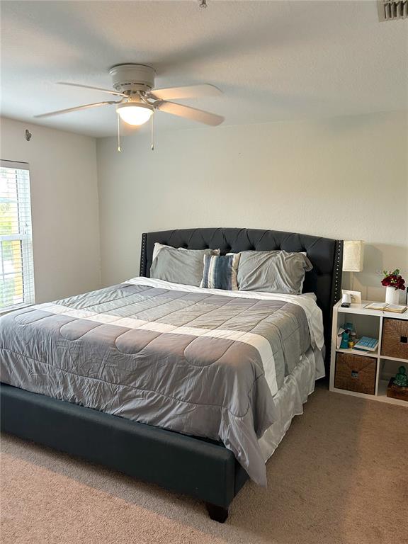 5447 Vineland Road, Unit 1209 Orlando, FL 32811 - Photo 24 of 27 a large bed sitting in a bedroom next to a window