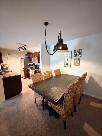 a living room with furniture a table and chairs