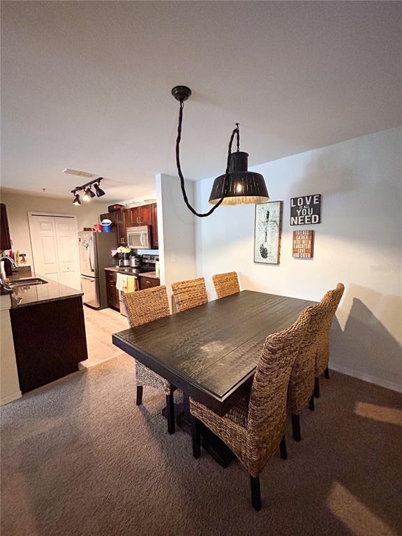 5447 Vineland Road, Unit 1209 Orlando, FL 32811 - Photo 3 of 27 a living room with furniture a table and chairs