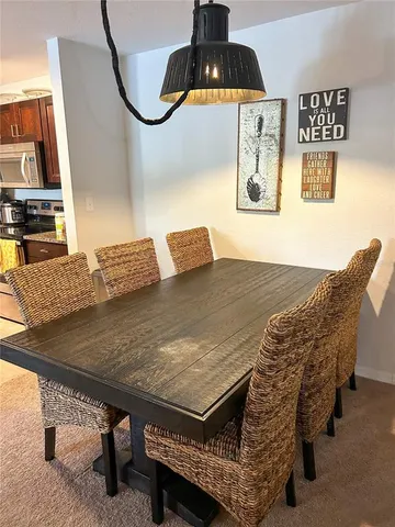 a living room with a table chairs and a stove