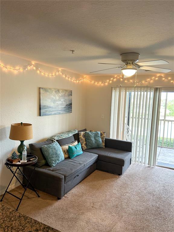 5447 Vineland Road, Unit 1209 Orlando, FL 32811 - Photo 10 of 27 a living room with furniture and a large window