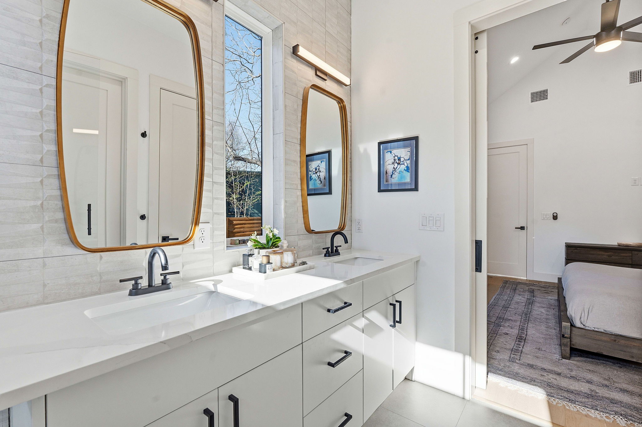 4313 Jinx Avenue, Unit 1 Austin, TX 78704 - Photo 20 of 40 Ensuite bathroom with double vanity, a ceiling fan, light tile patterned floors, and a high ceiling