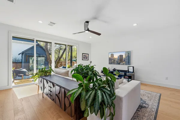 a living room with furniture and a potted plant