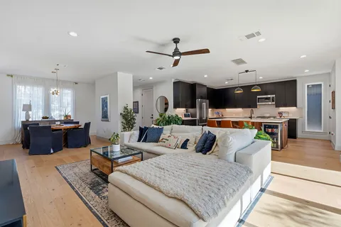 a living room with furniture kitchen view and a table