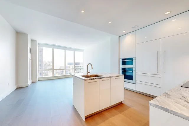 a kitchen with stainless steel appliances granite countertop a stove and a refrigerator