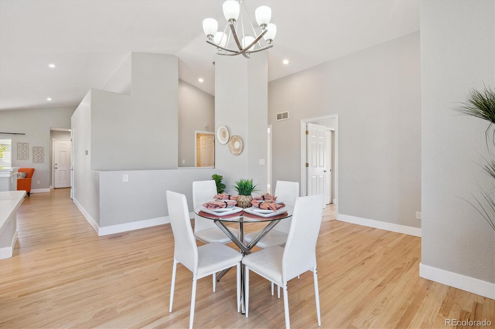 9793 Burberry Way Highlands Ranch, CO 80129 - Photo 14 of 29 a view of a dining room with furniture and wooden floor