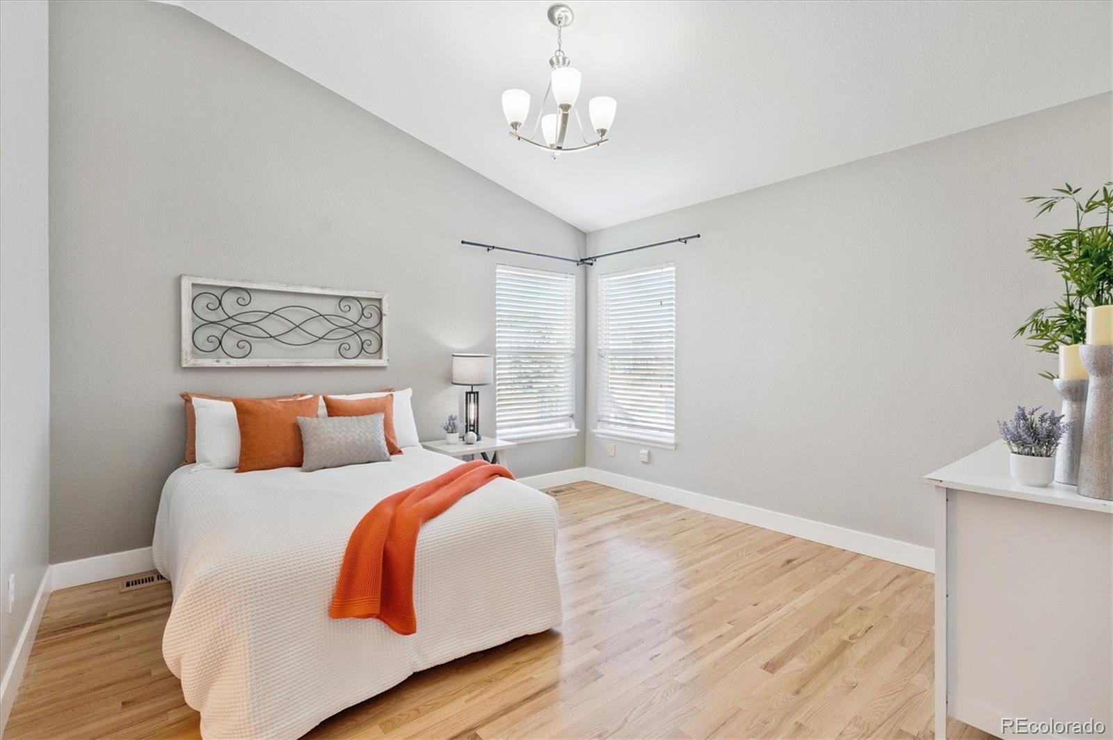 9793 Burberry Way Highlands Ranch, CO 80129 - Photo 15 of 29 a bedroom with a bed and wooden floor