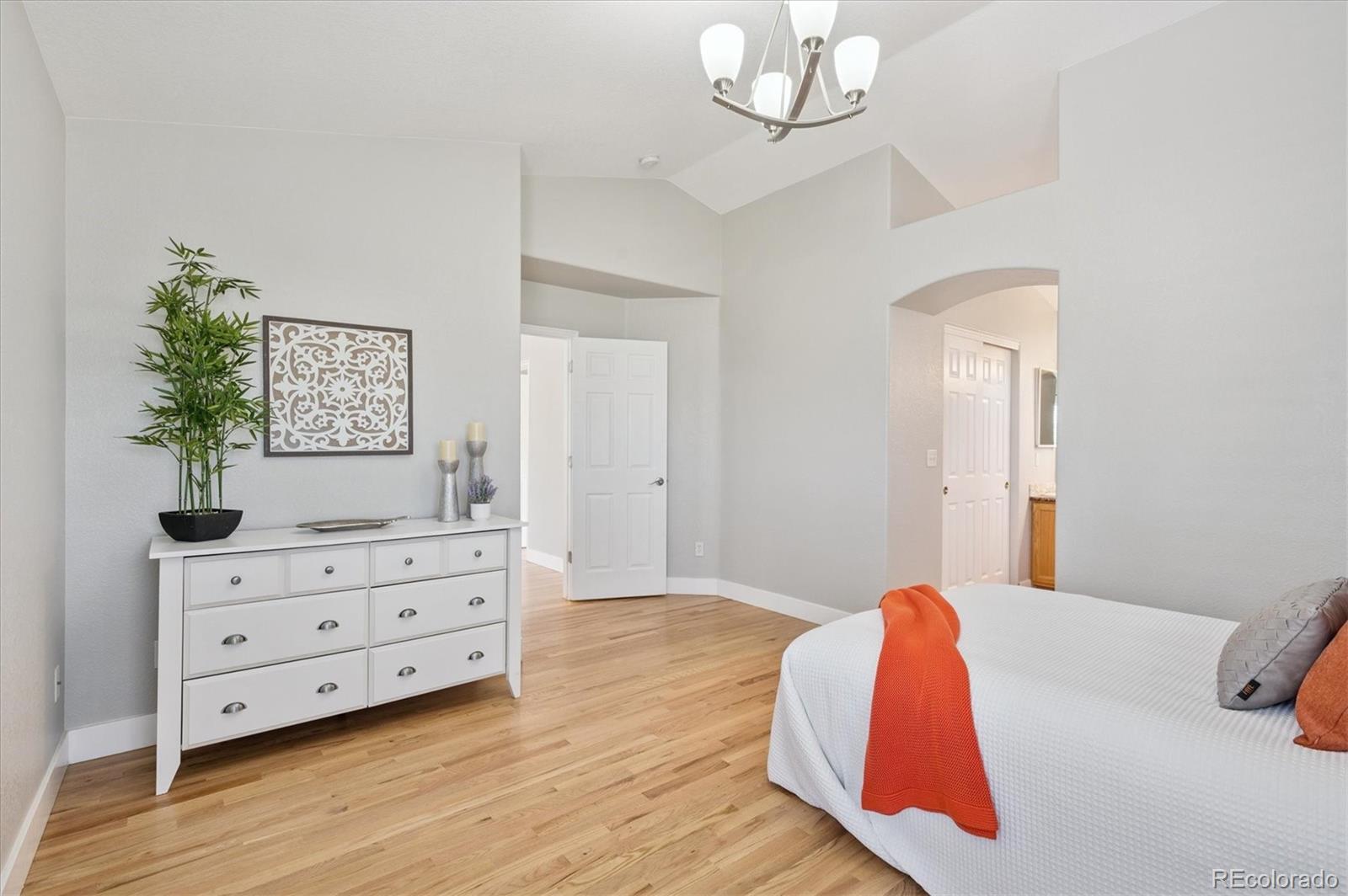 9793 Burberry Way Highlands Ranch, CO 80129 - Photo 16 of 29 a view of a bedroom with wooden floor and cabinet