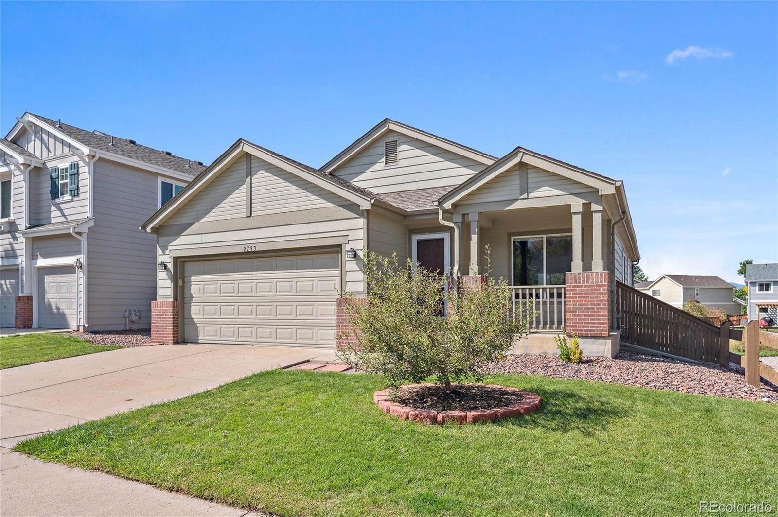 9793 Burberry Way Highlands Ranch, CO 80129 - Photo 2 of 29 a front view of a house with a garden