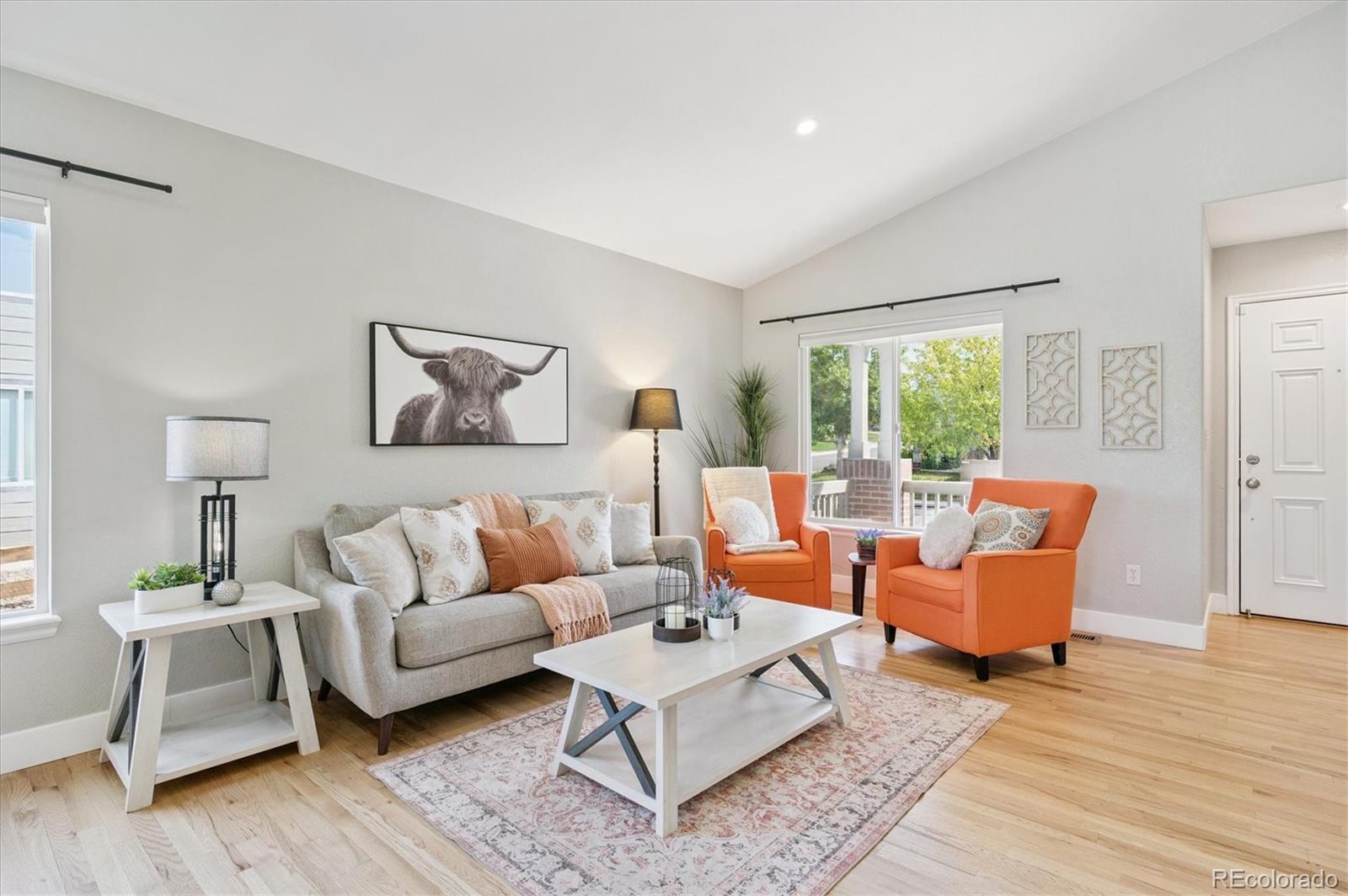 9793 Burberry Way Highlands Ranch, CO 80129 - Photo 4 of 29 a living room with furniture and wooden floor
