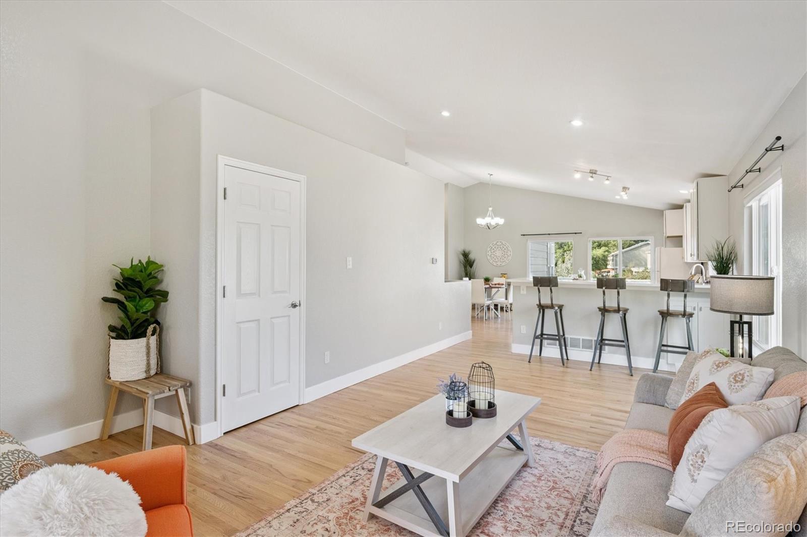 9793 Burberry Way Highlands Ranch, CO 80129 - Photo 6 of 29 a living room with furniture potted plant and kitchen view
