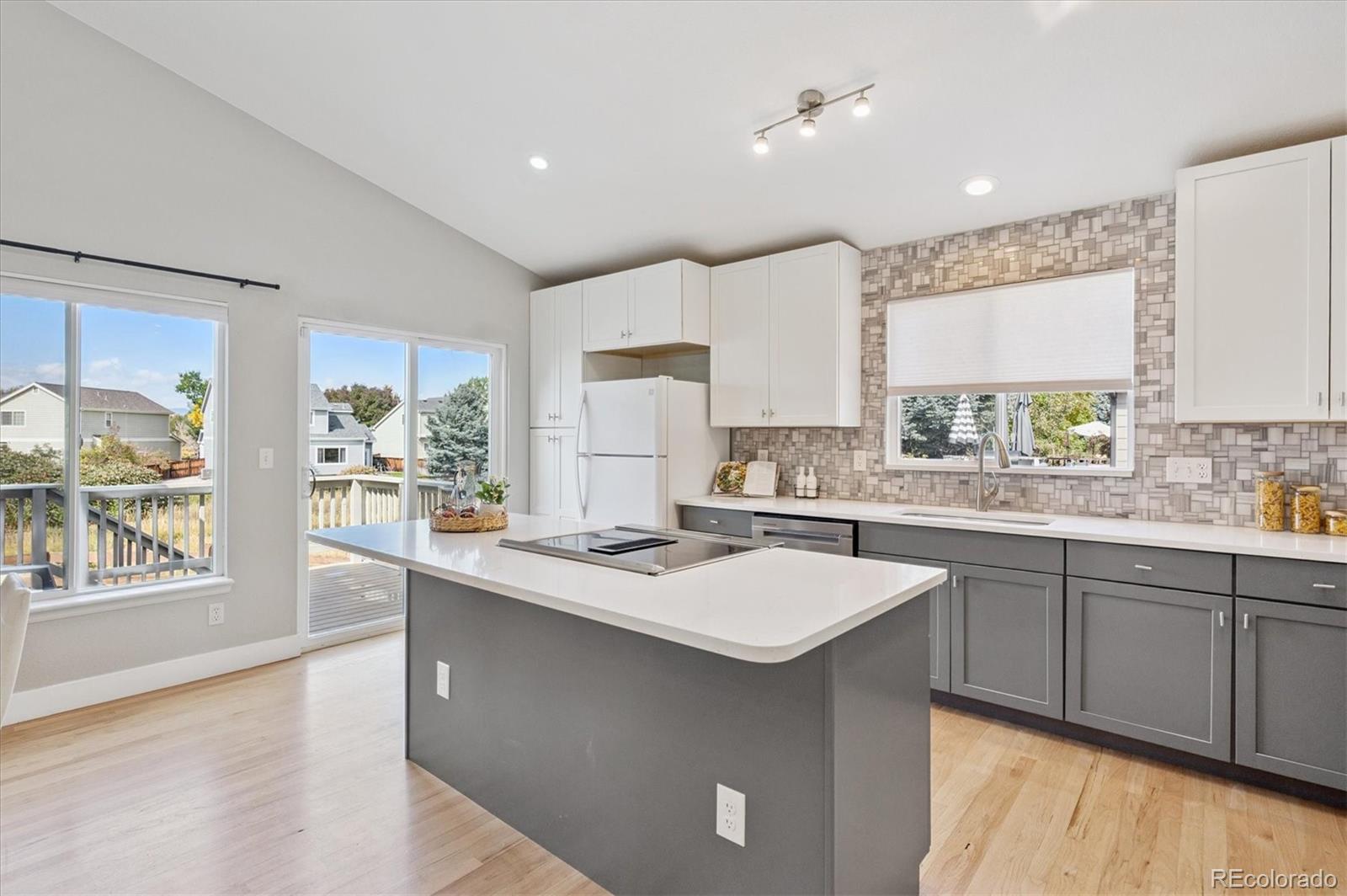 9793 Burberry Way Highlands Ranch, CO 80129 - Photo 9 of 29 a kitchen with sink a window and chairs