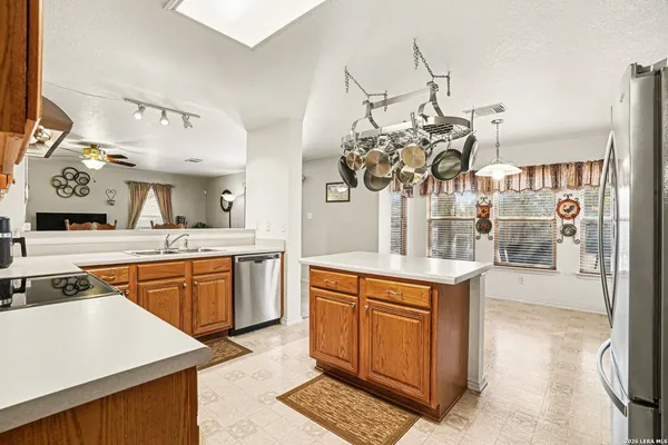 a kitchen with stainless steel appliances granite countertop a sink and cabinets
