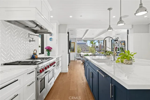 a kitchen with stainless steel appliances granite countertop a sink and a stove