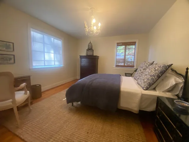 a bedroom with a bed and chair