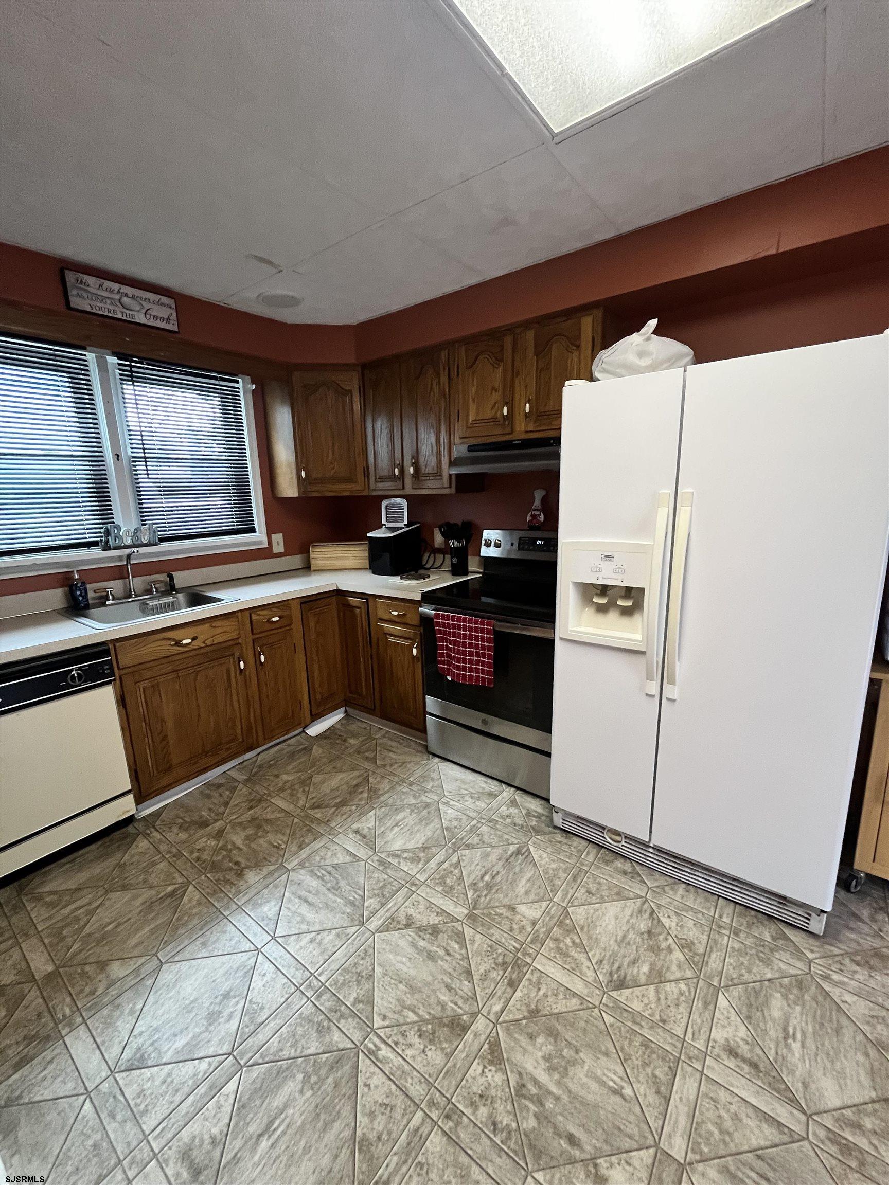 657 5th Street Somers Point, NJ 08244 - Photo 2 of 2 a kitchen with granite countertop a refrigerator and a stove