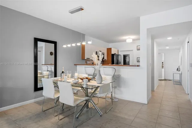 a dining room with furniture and a kitchen view