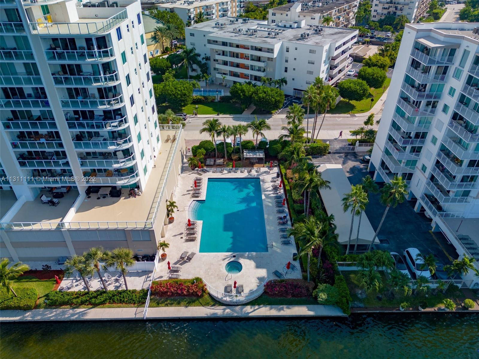 18100 North Bay Road, Unit 308 Sunny Isles Beach, FL 33160 - Photo 14 of 35 an aerial view of multiple houses with yard swimming pool and outdoor seating