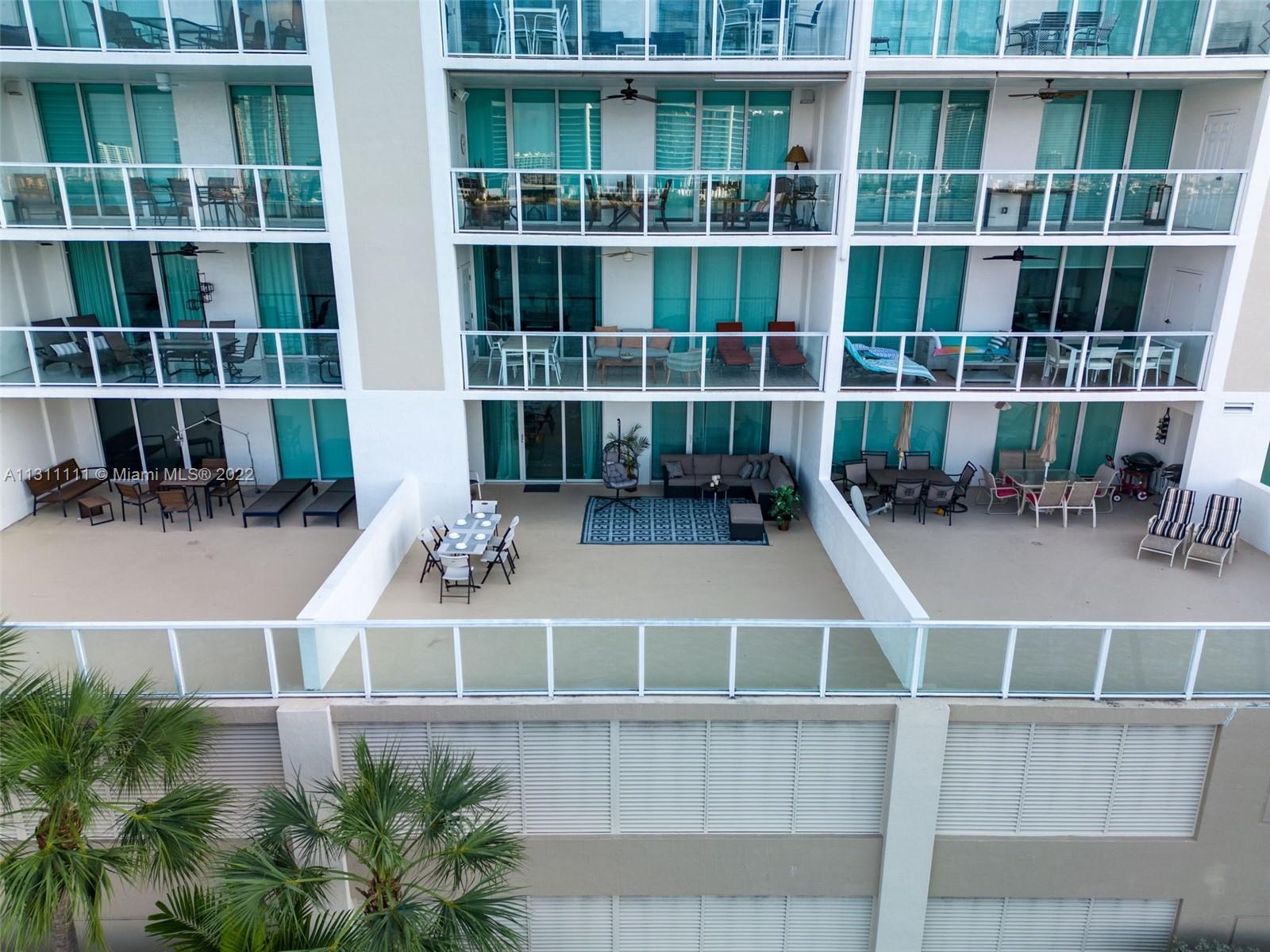 18100 North Bay Road, Unit 308 Sunny Isles Beach, FL 33160 - Photo 16 of 35 a view of a balcony with chairs and potted plants