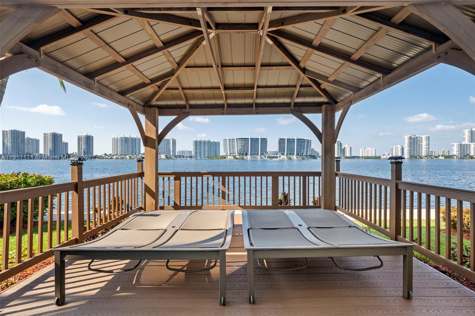 18100 North Bay Road, Unit 308 Sunny Isles Beach, FL 33160 - Photo 20 of 35 a view of a balcony with furniture and wooden floor