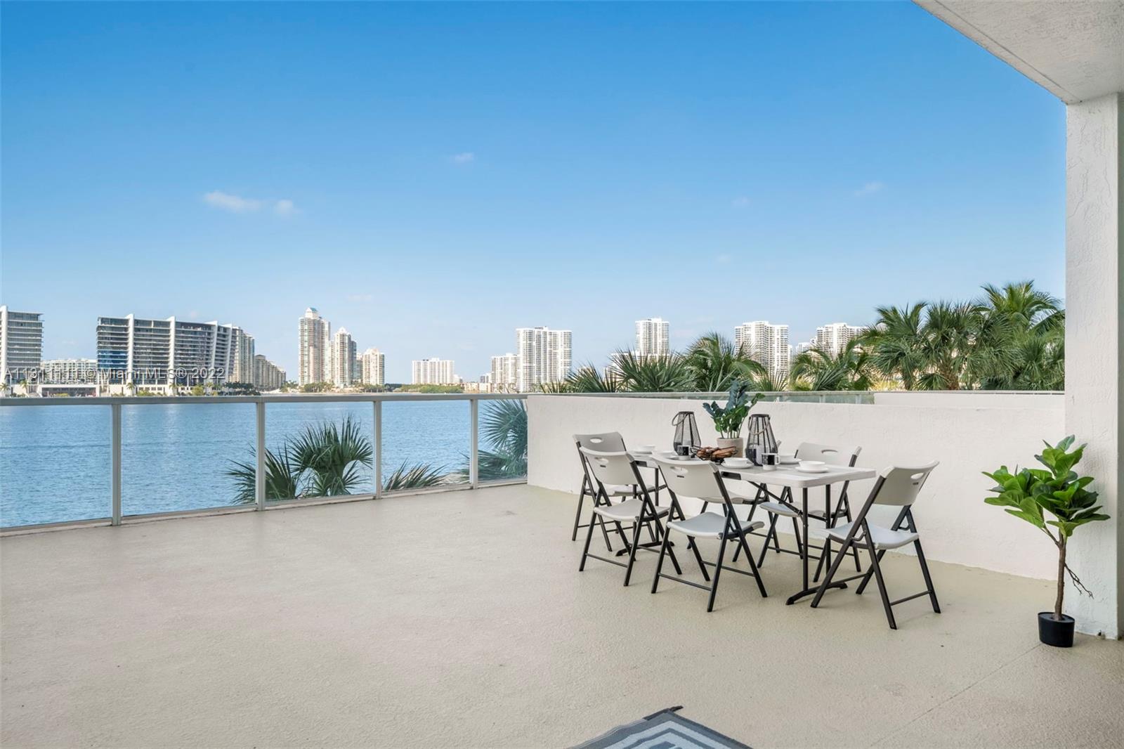 18100 North Bay Road, Unit 308 Sunny Isles Beach, FL 33160 - Photo 22 of 35 a view of a terrace with furniture and a potted plant