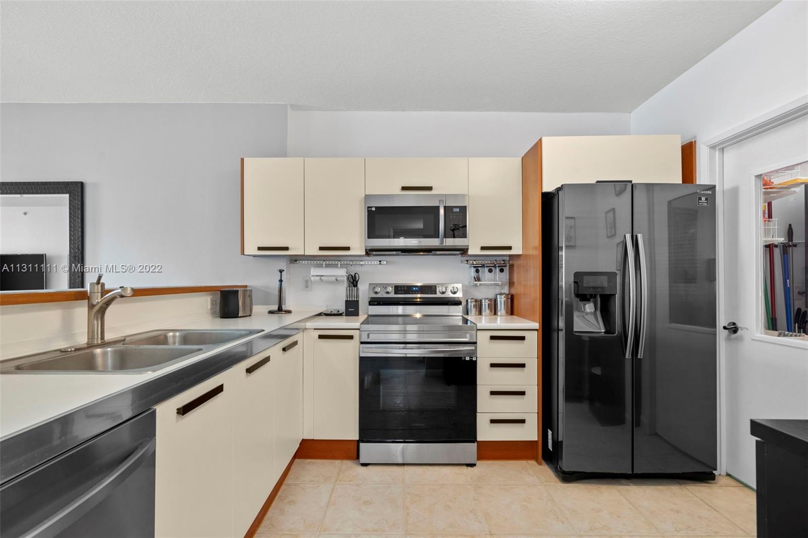18100 North Bay Road, Unit 308 Sunny Isles Beach, FL 33160 - Photo 27 of 35 a kitchen with a sink stove and refrigerator